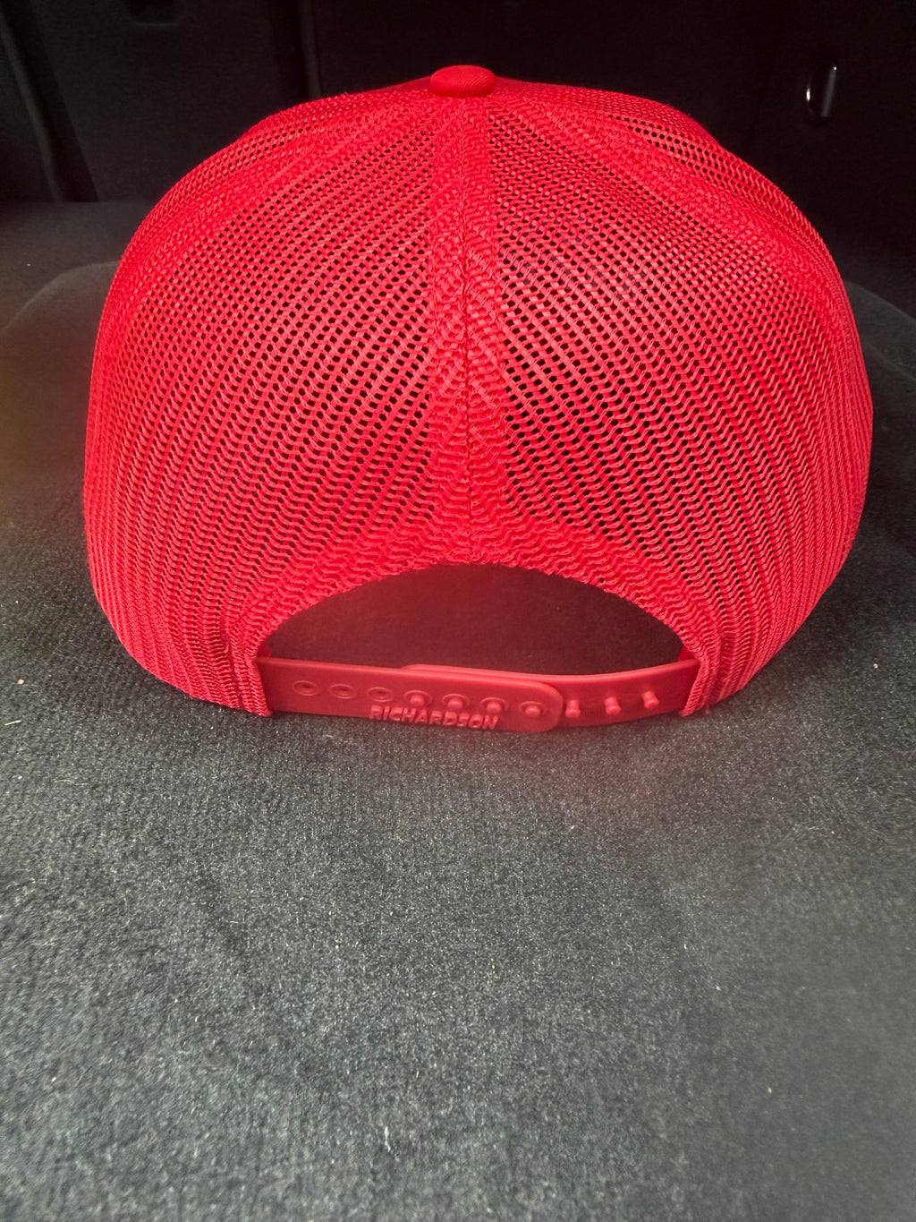 Red mesh snapback cap with 'tired as a mother' text.